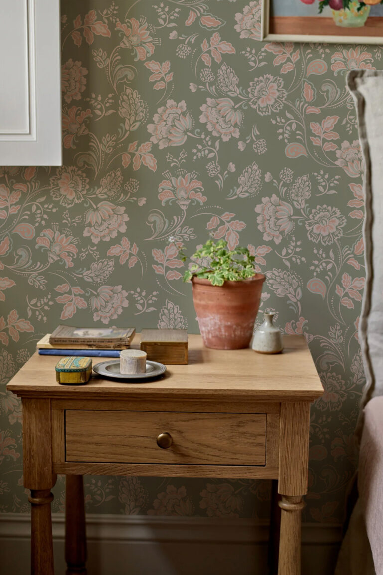 AMELIE LICHEN olive green background with pink and beige flower design used in bedroom with natural wood bedside table and plant