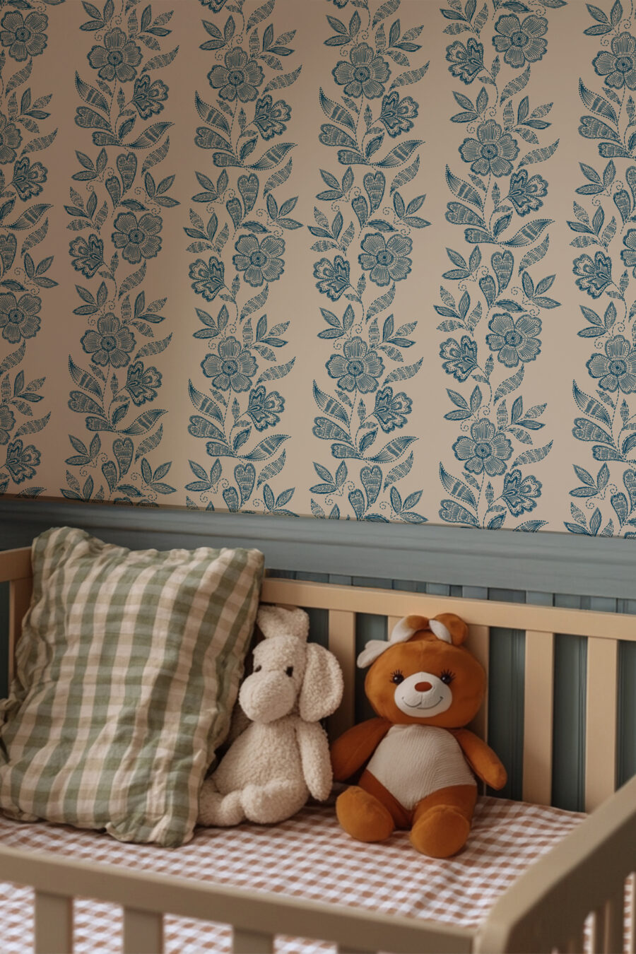 Dilys Teal Wallpaper in Bedroom beige background with dark blue flower and leaf pattern in a baby's nursery with cot and 2 teddies