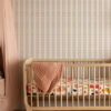 Rosalie Soft Pink Wallpaper with cream background and light pink green repeating abstract patternused on wall in Nursery bedroom. Mina is part of our home decor collection The Portrait Collection.