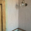 Our Maeva wallpaper in rouge, soft pink ditsy floral wallpaper shown here in a bathroom renovation, modern twist on a classic interior. Victorian house bathroom renovation