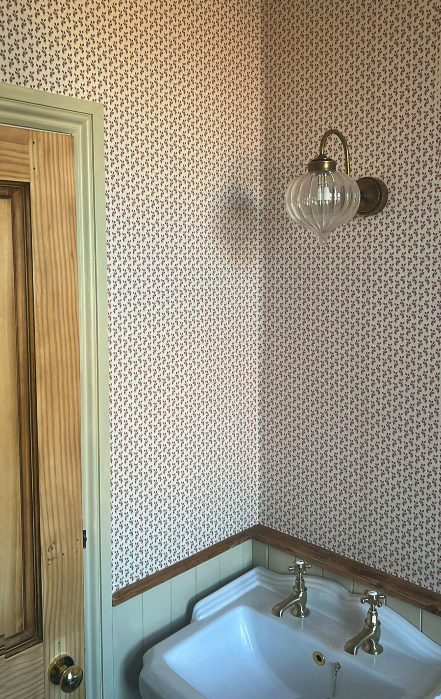 Our Maeva wallpaper in rouge, soft pink ditsy floral wallpaper shown here in a bathroom renovation, modern twist on a classic interior. Victorian house bathroom renovation