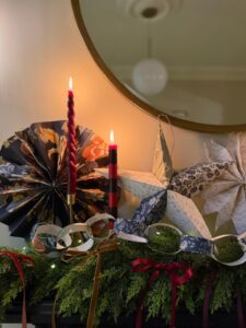 Beautiful wallpaper christmas decorations on a fireplace with candles and a garland