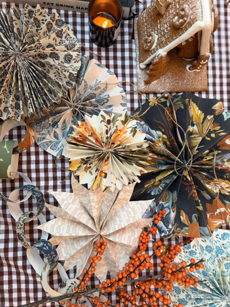 A table filled with beautiful handmade Christmas decorations made from wallpaper leftovers by Curate Space