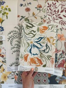 Wallpaper sample by Curate Space held by someone's hand